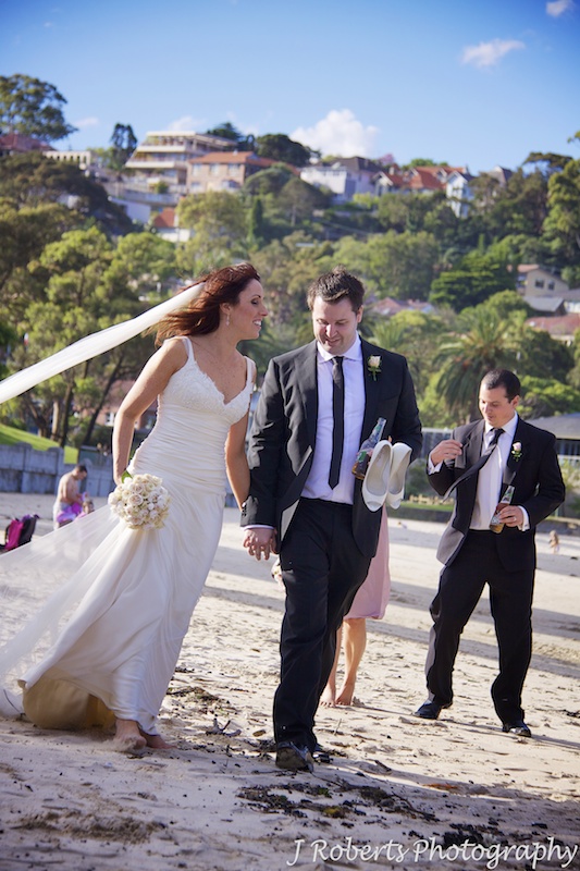 Bride and groom walking along Balmoral Beach - wedding photogrpahy sydney